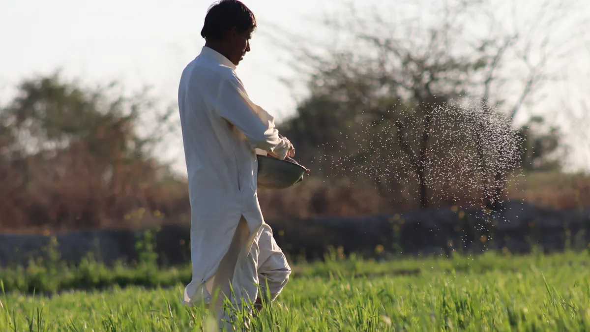 Application by landscape area — The Complete Guide Man spraying crop rows by hand