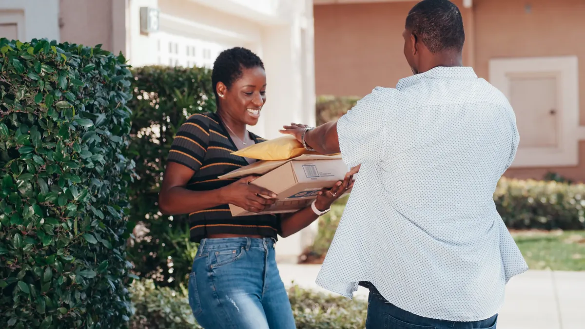 person receiving a parcel at the door