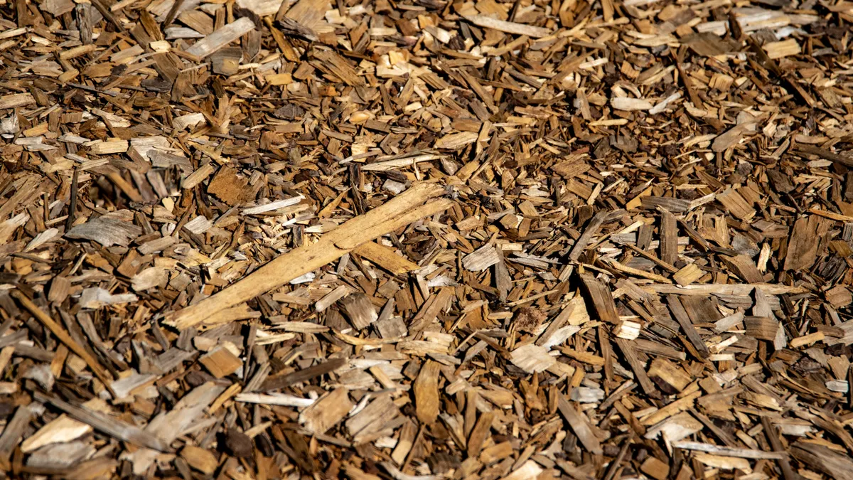 Is Colored Mulch Safe for Vegetable Gardens and Around Kids or Pets? Close-up of light brown wood mulch chips