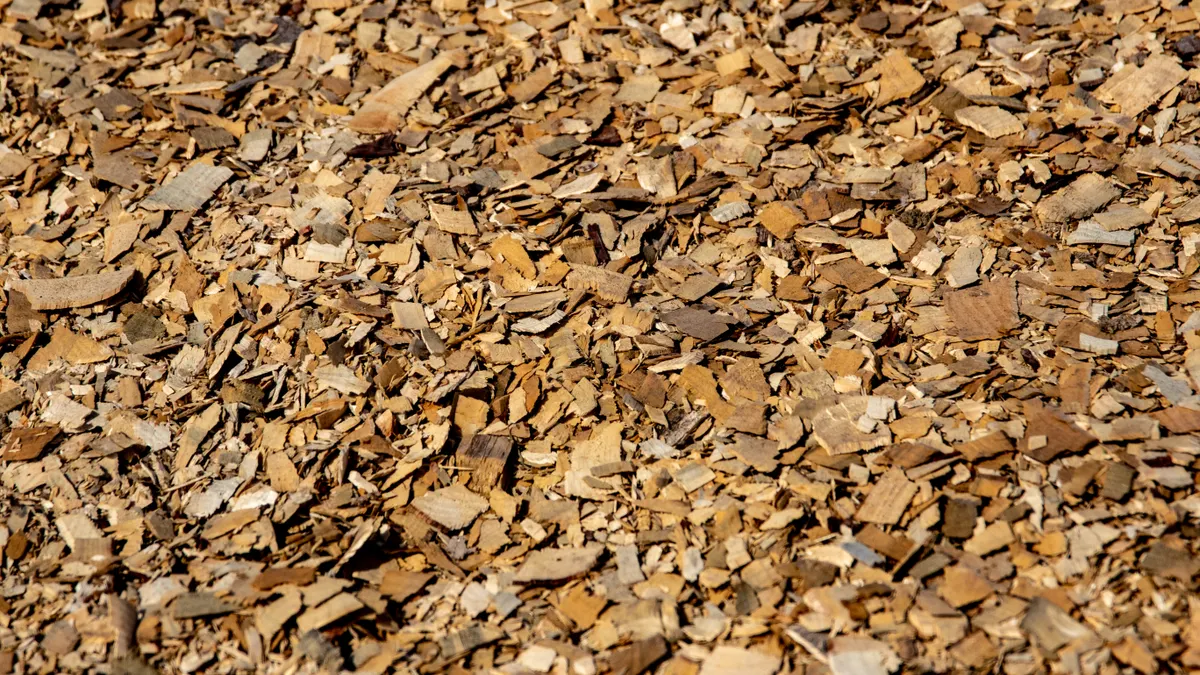 What to Do When Your Mulch Order Lands Short or Runs Long Light tan wood chip mulch close-up